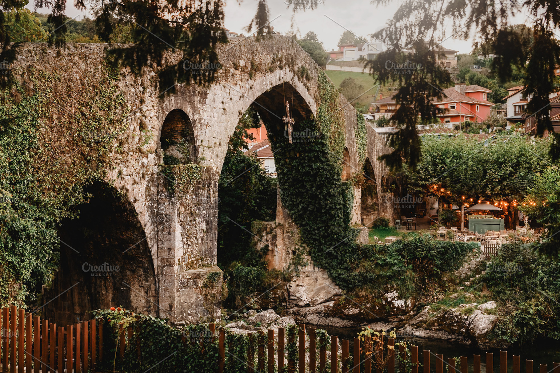 Ivy-covered Roman bridge at dusk in, an Architecture Photo by Perpis