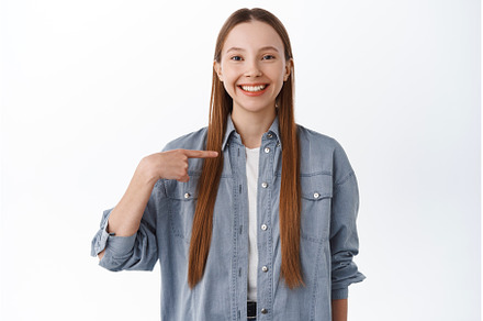 Happy confident girl pointing at, a Beauty & Fashion Photo by Cookie Studio