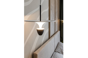 Modern pendant lamp above cozy bed, a Background Photo by wip3out