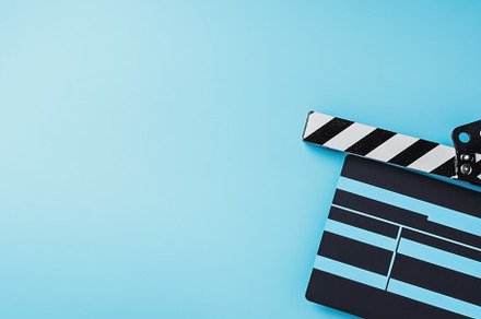 Clapperboard on a blue background re, a Photo by Iftikhar Alam