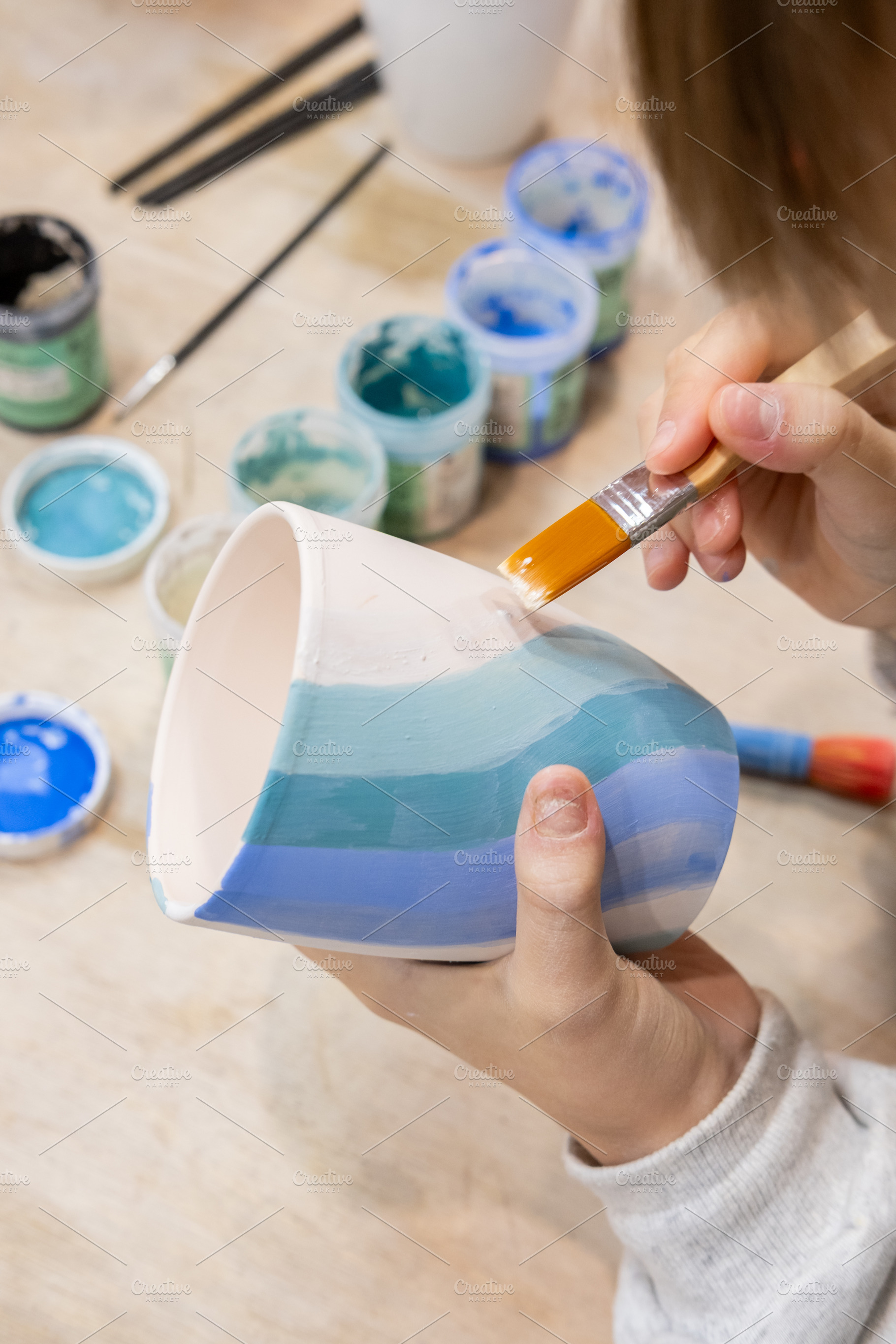Ceramic art pottery class child hand painting, an Arts & Entertainment Photo by Photo Drive Studio
