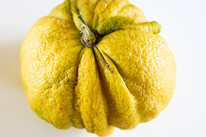 Close-up of a wrinkled yellow citrus, a Food & Drink Photo by Imaginarium