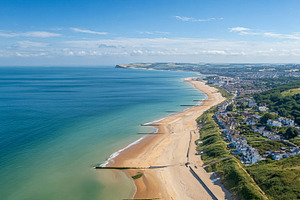 Bournemouth coastline aerial view showing golden sand beach, tur, a Photo by Studio ANNA