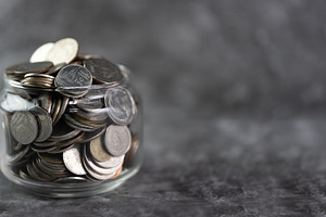 Coins in a glass jar Savings and inv