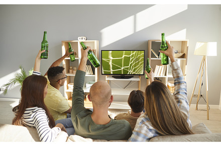 Young people relax at home with beer, a Sports & Recreation Photo by StudioRomantic