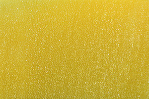 Detail of texture of synthetic yellow sponge with tiny holes, an Abstract Photo by Davizro's Market