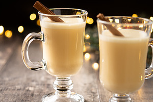 Creamy eggnog with cinnamon sticks and Christmas lights, a Food & Drink Photo by etorres69