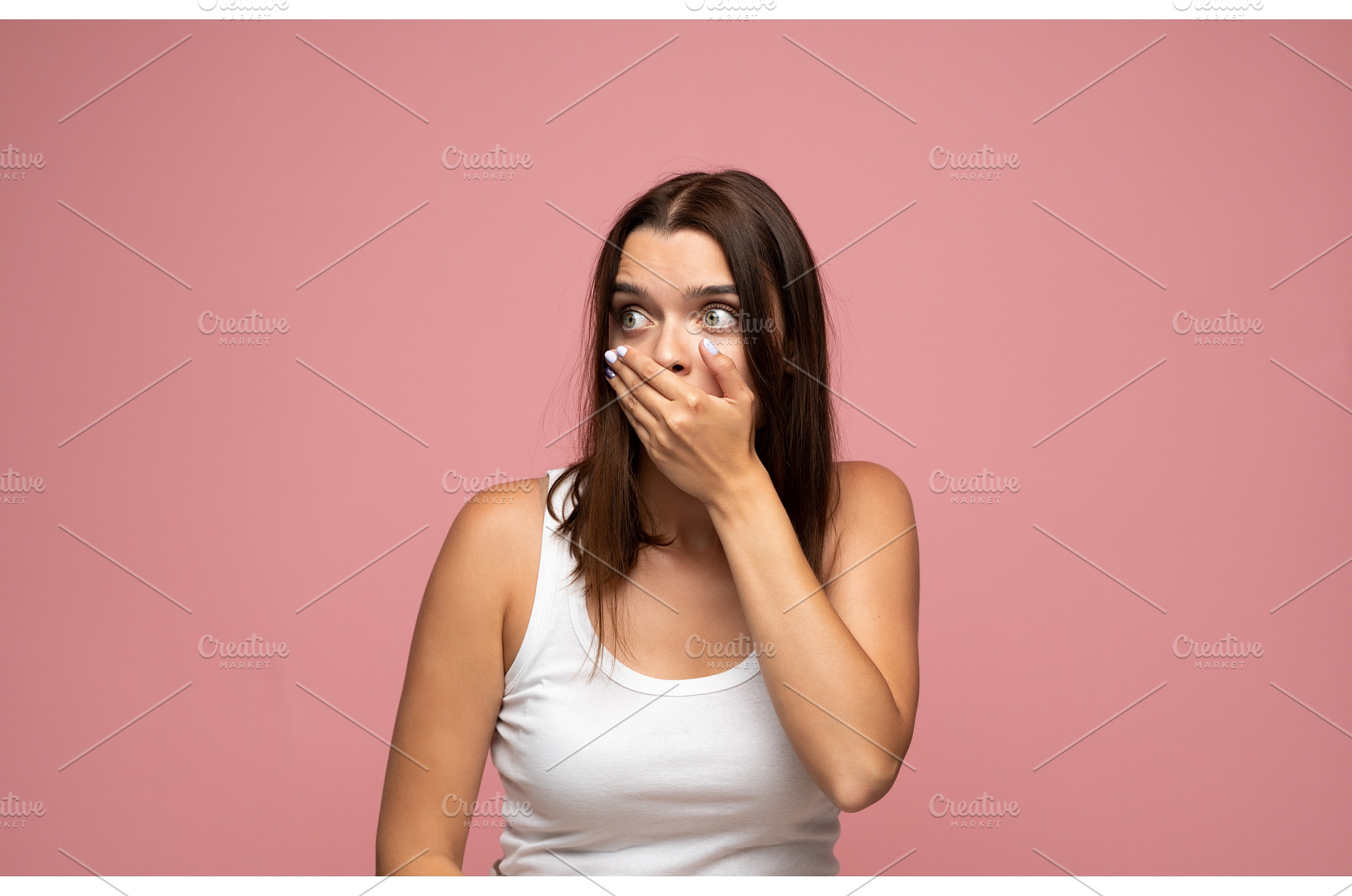 Young woman covering mouth in shock, a Person Photo by volodymyrshtun13795