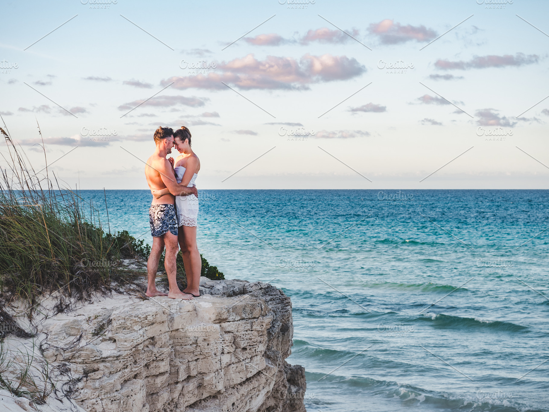 Handsome man and pretty woman stand against the backdrop of a rock, a Person Photo by Svetlana Barchan