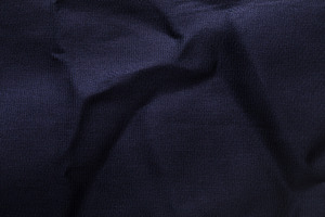 Close-up of dark blue textile with soft folds and subtle texture, a Background Photo by Ales Munt