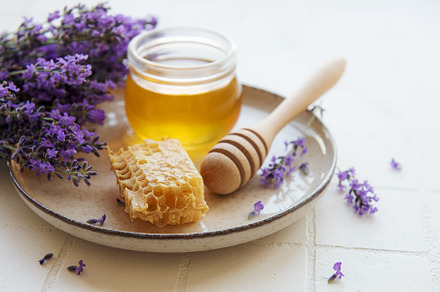 Jar with honey and fresh lavender flowers, a Food & Drink Photo by Olena Rudo