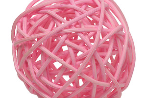 Pink wicker rattan ball on white background, which is a decorati, an Abstract Photo by ndanko