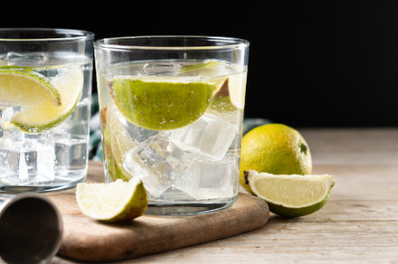 Glass of vodka tonic cocktail on wooden table, a Food & Drink Photo by etorres69