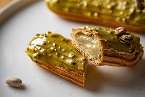 Pistachio eclairs with light green icing, a Photo by Grafvision photography