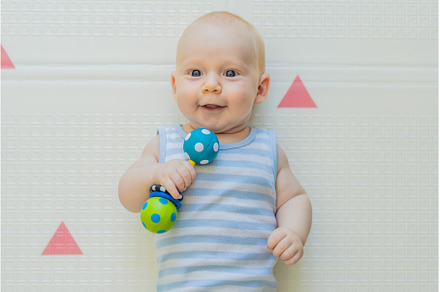 Adorable baby playing with colorful