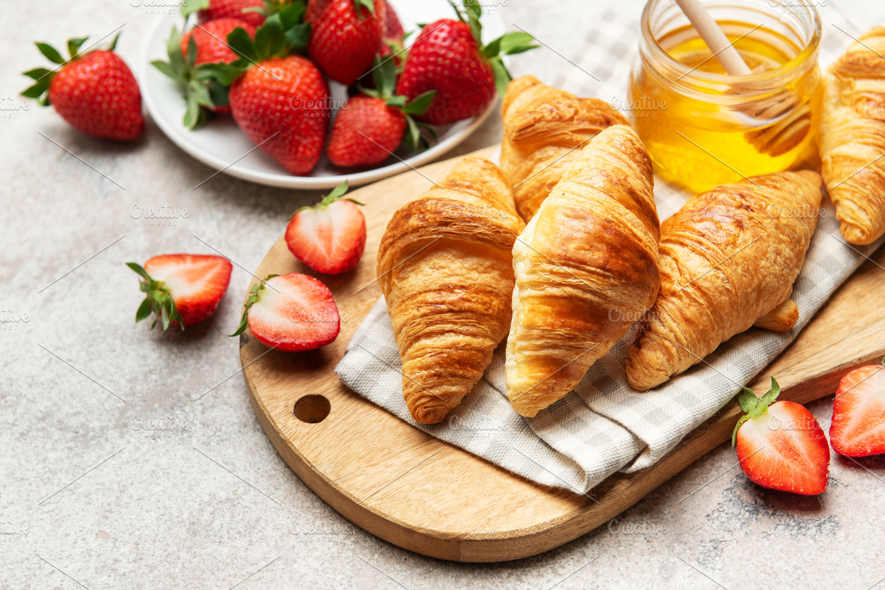 Delicious french croissants with fresh strawberries and honey fo, a Food & Drink Photo by Olena Rudo