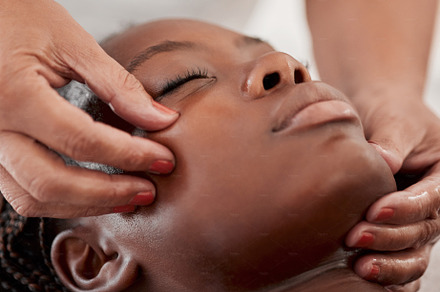 Black woman face, massage and spa wellness therapist  with young female and cosmetic facial. Skincare, beauty and dermatology clinic with client feeling calm and zen from hyaluronic acid serum, a Photo by Peopleimages.com