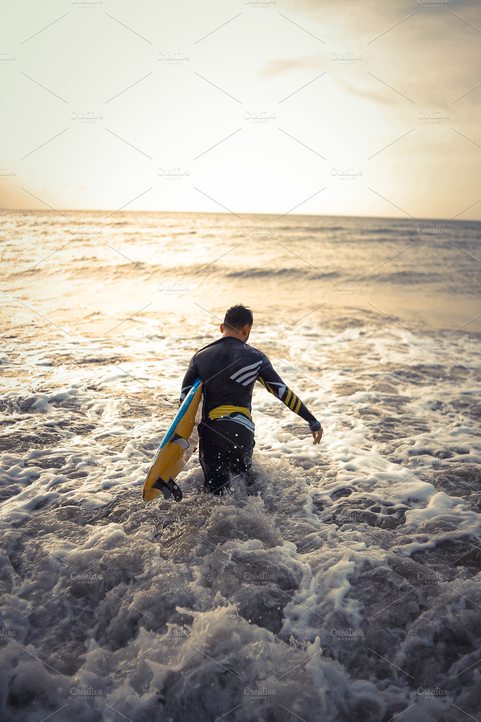Surfer Entering Ocean at Sunset, a Sports & Recreation Photo by bastera