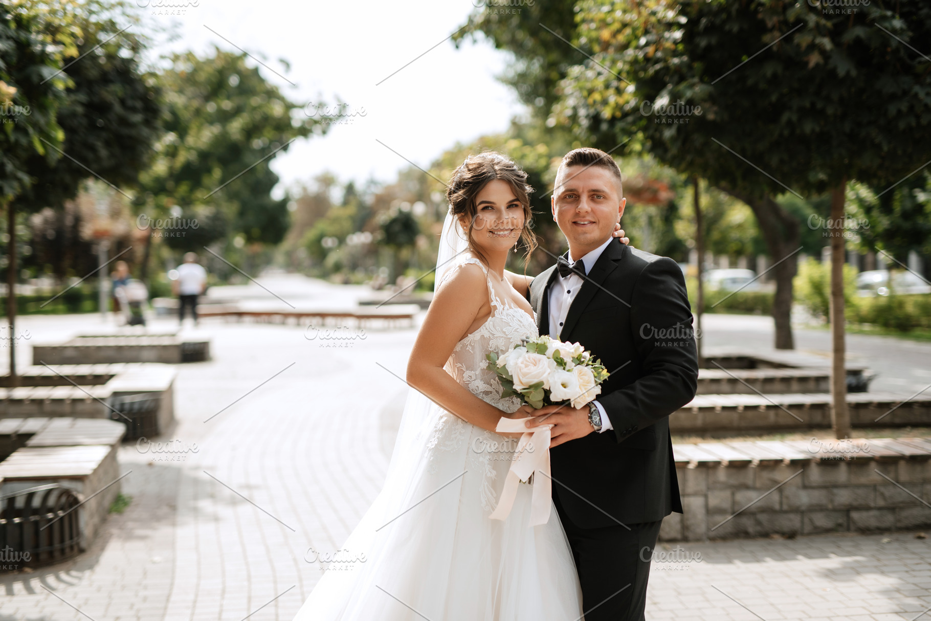 the groom in a brown suit and the bride in a white dress, a Person Photo by Weddings, People, Travel