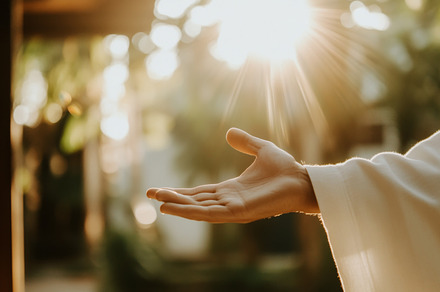 Hand of Jesus reaching out with light in spiritual scene, copy s, a Photo by Dvoevnore photos