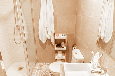 Bathroom with shower, toilet and sink with mirror from hotel, a Beauty & Fashion Photo by Iván Moreno STOCK PHOTO