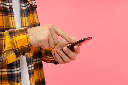 Man using phone on pink background, space for text, a Person Photo by AtlasStudio PRO