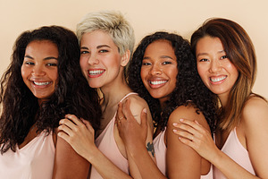 Group of smiling females standing, a Person Photo by Artem Varnitsin