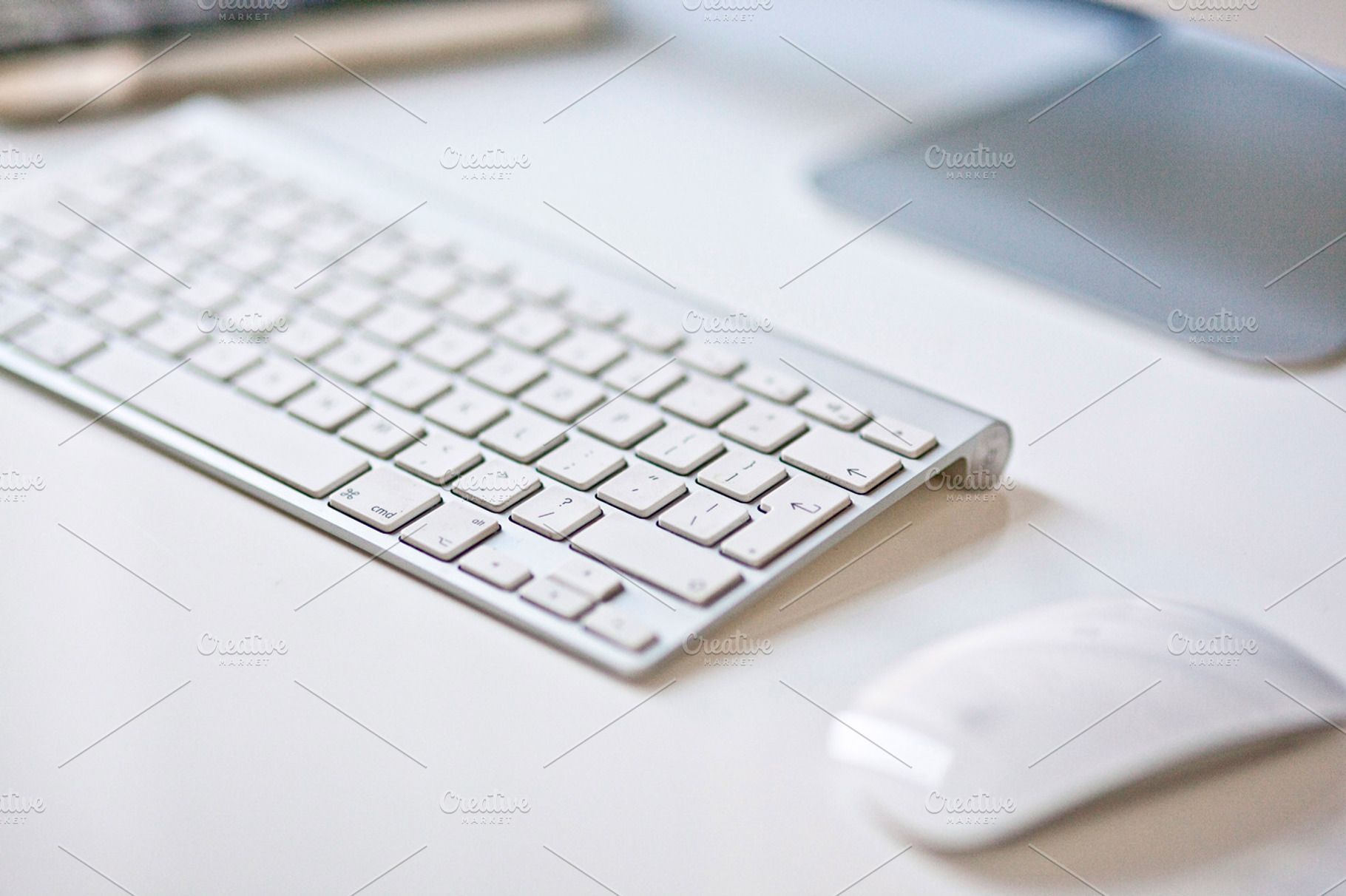 Keyboard in the workplace containing keyboard, mouse, and apple