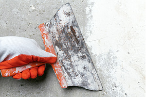 Hand of plasterer holds old trowel, an Industrial Photo by Alexander-Piragis