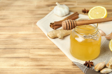 Concept of treatment colds with honey and garlic on  wooden back, a Health & Medical Photo by AtlasStudio PRO