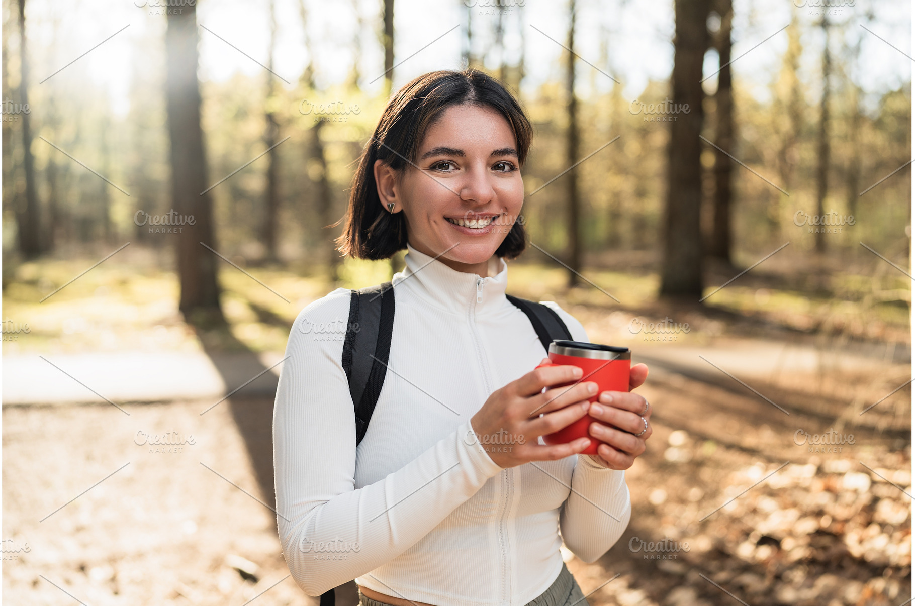 Hiker woman pausing in a forest to, a Nature Photo by AD Stock Images