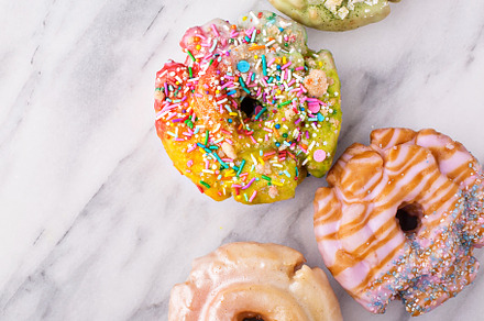 Variety of donuts on a marble surfac containing variety, colorful, and gourmet, a Food & Drink Photo by farwasser