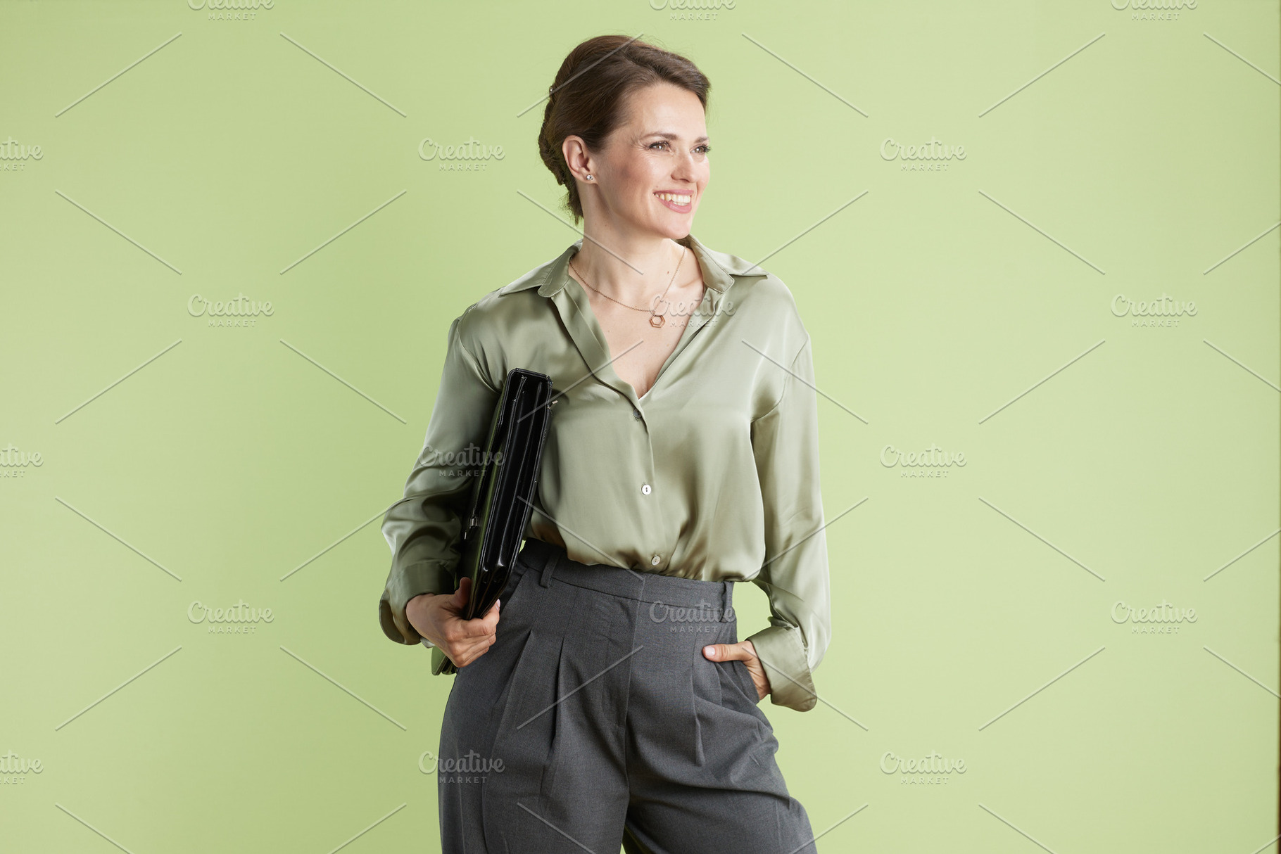 Confident professional woman with portfolio, a Person Photo by Alliance Images