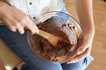 Woman preparing Christmas cookies - stirring cream