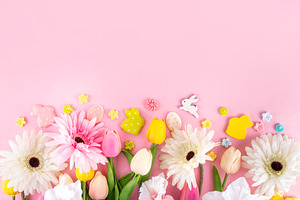 Beautiful spring flowers bouquet with Easter decorations on pink, a Holiday Photo by Rimma