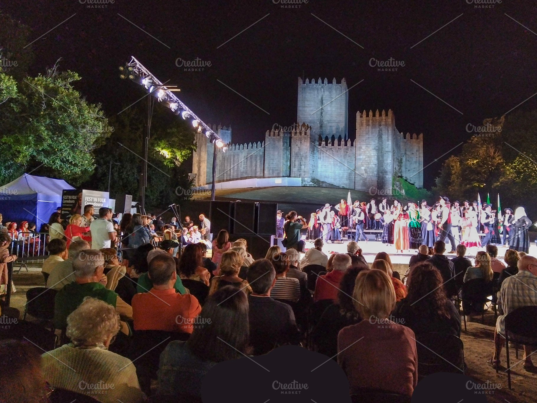 Folk dancers performing at night before medieval castle, a Holiday Photo by DanFLCreativo