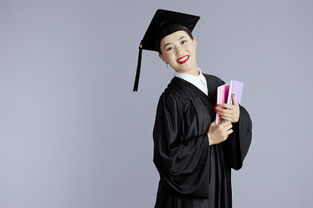 happy female asian graduate student against grey, a School & Education Photo by Alliance Images