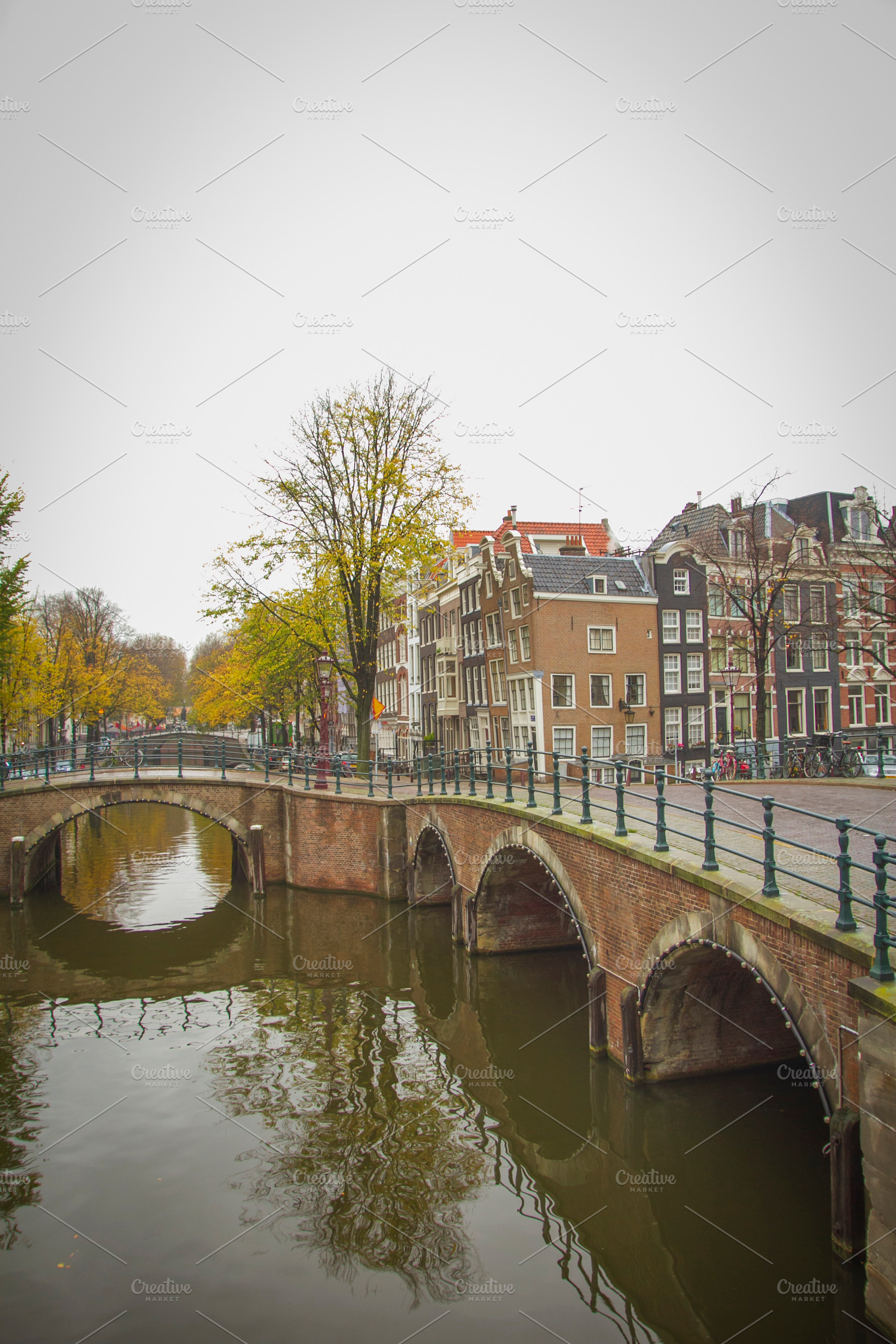 Historic brick bridges over Amsterdam canals in autumn, vertical, a Photo by Pictures for you!!!!!!!!!