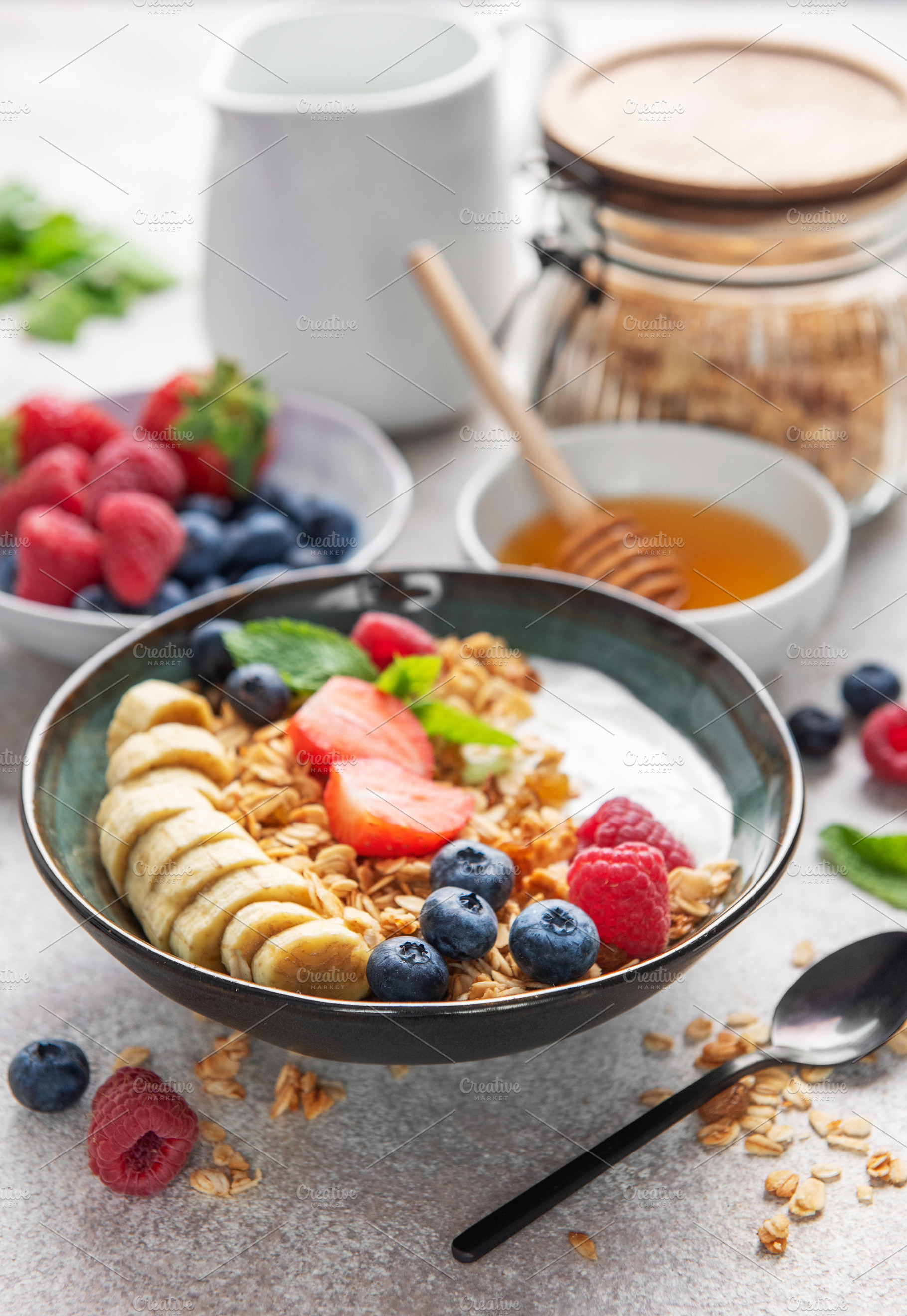 Delicious granola with yogurt, banana, and berries creating a nu, a Food & Drink Photo by Olena Rudo