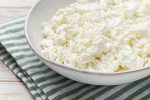 Cottage cheese in bowl with striped napkin, a Food & Drink Photo by Olena Rudo