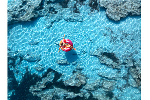 Aerialview of woman relaxing on pink, a Nature Photo by den-belitsky
