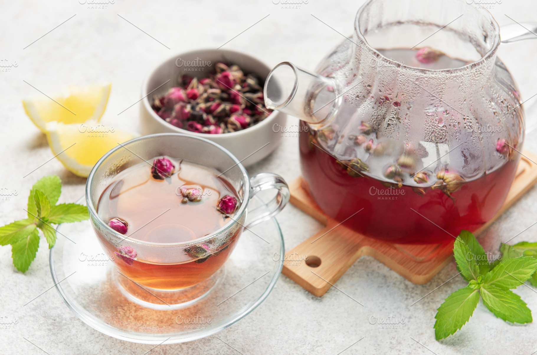 Pouring fragrant rose tea into a transparent cup, a Food & Drink Photo by Olena Rudo