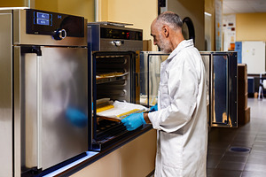 Scientist working with an incubator, a Health & Medical Photo by Perpis