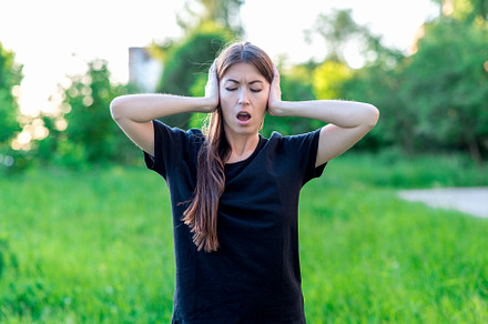 Girl summer in fresh air. I closed my ears with my hands and opened my mouth. Emotions of loud noise. Discontented situation. Emotional expression. Loud noise screams of migraine., a Person Photo by byswat