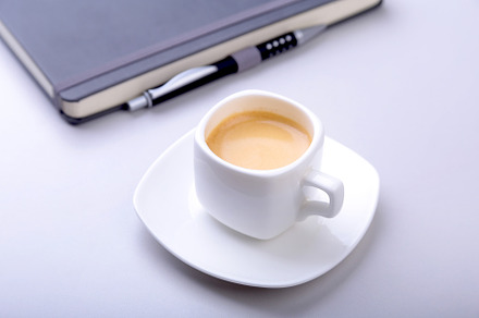 White cup with a fragrant espresso containing computer, desk, and coffee, a Business Photo by Vi Style