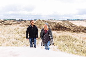 Couple hiking through the dunes containing outdoor, sport, and active