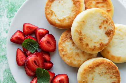 Cottage cheese pancakes, ricotta fritters on ceramic plate with, a Food & Drink Photo by Olena Rudo