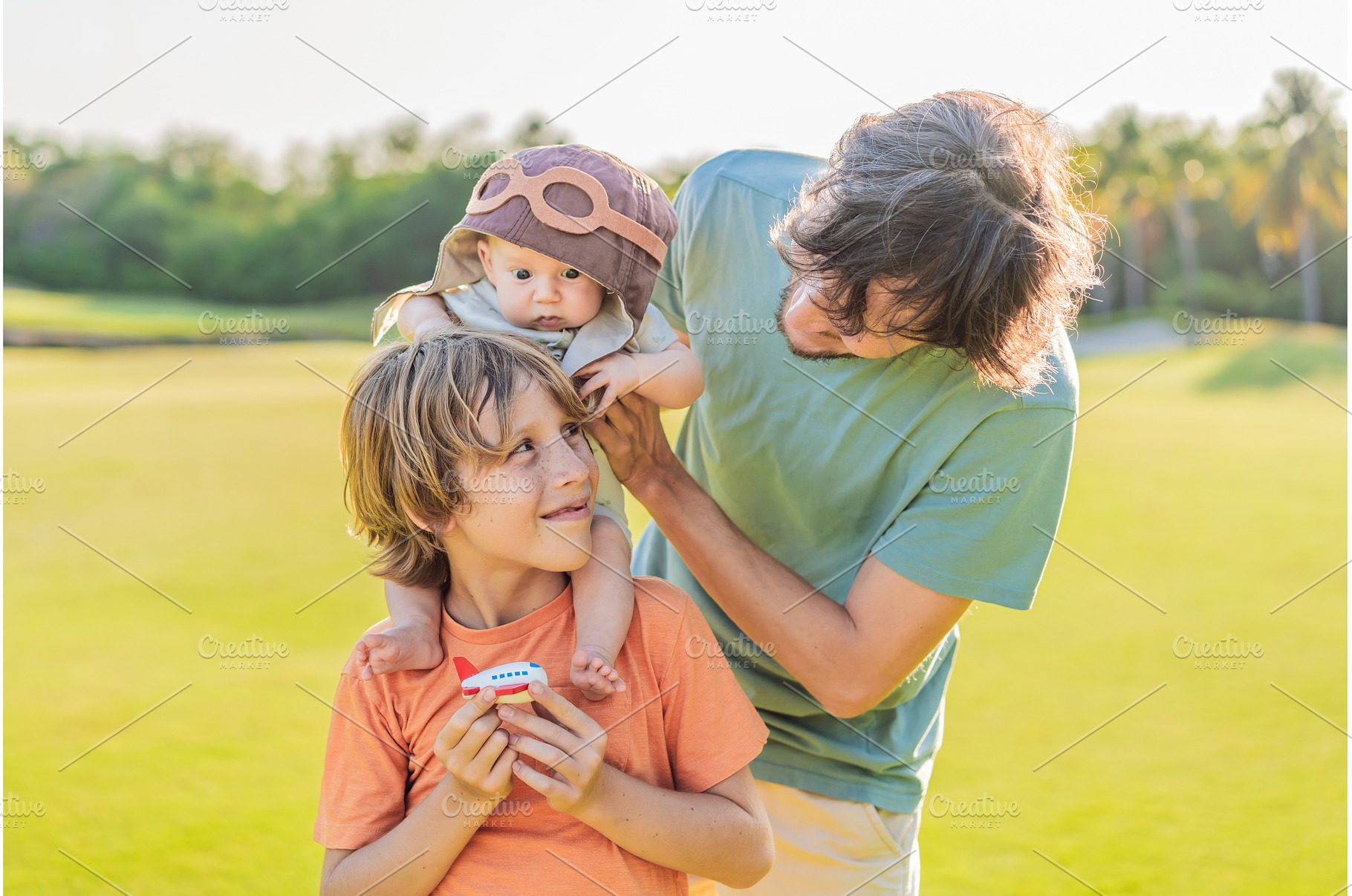 Father, son, and newborn on a meadow, a Person Photo by Elizaveta Galitskaya