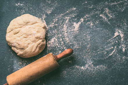 Dough with rolling pin on blue, a Food & Drink Photo by VICUSCHKA