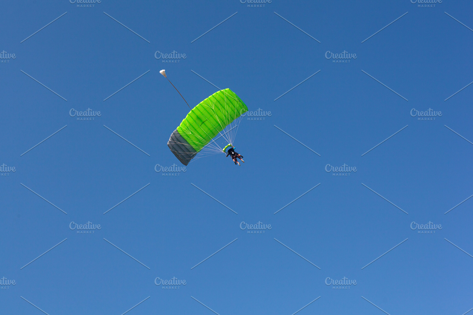 A paraglider with a green parachute is descending down to Kanin, Slovenia,, a Sports & Recreation Photo by Bepslabor